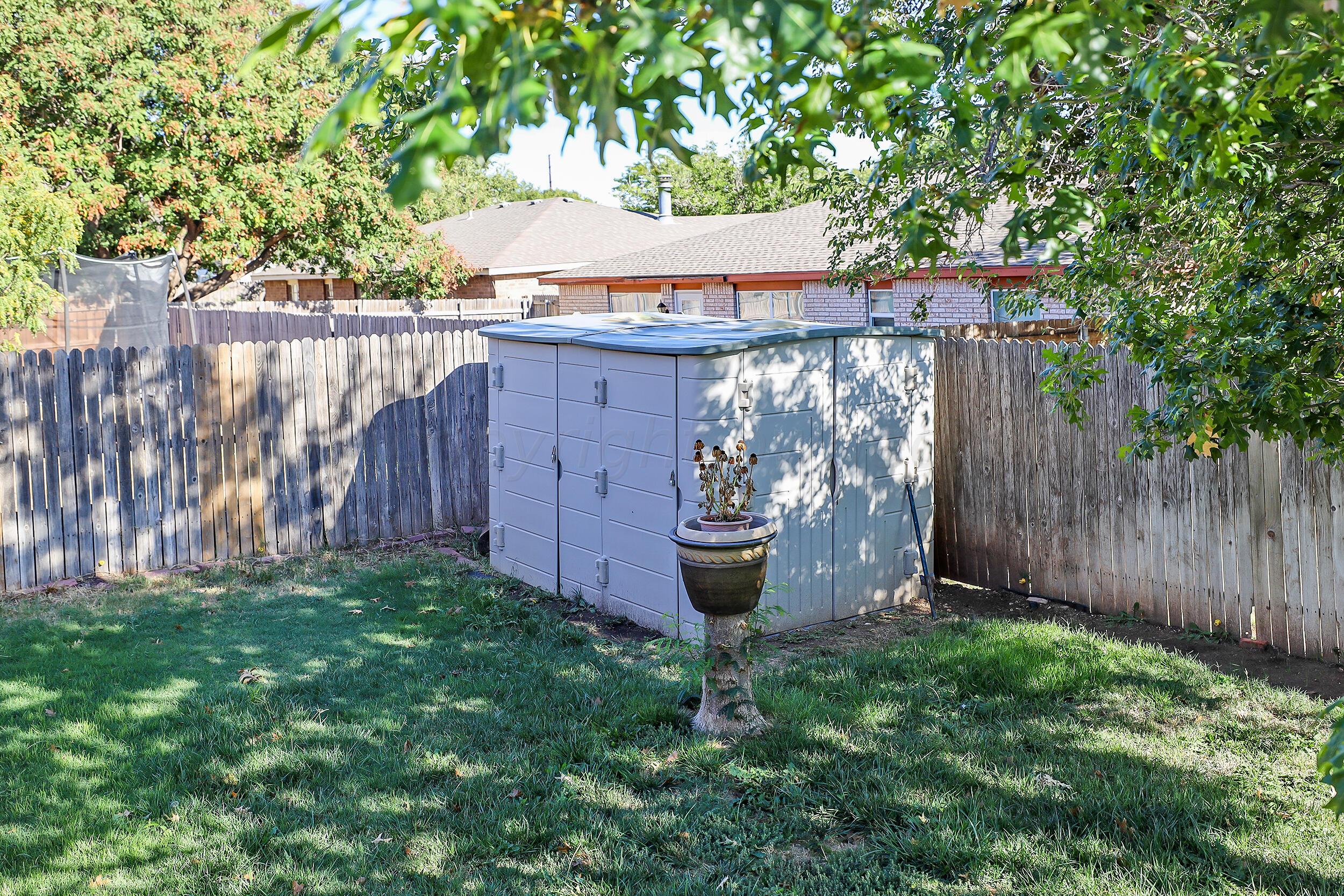 2905 Salem Drive Amarillo, TX 79110 - Photo 29 of 29 a view of a backyard with wooden fence and a bench