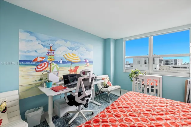 a bedroom with a bed and a dresser in it