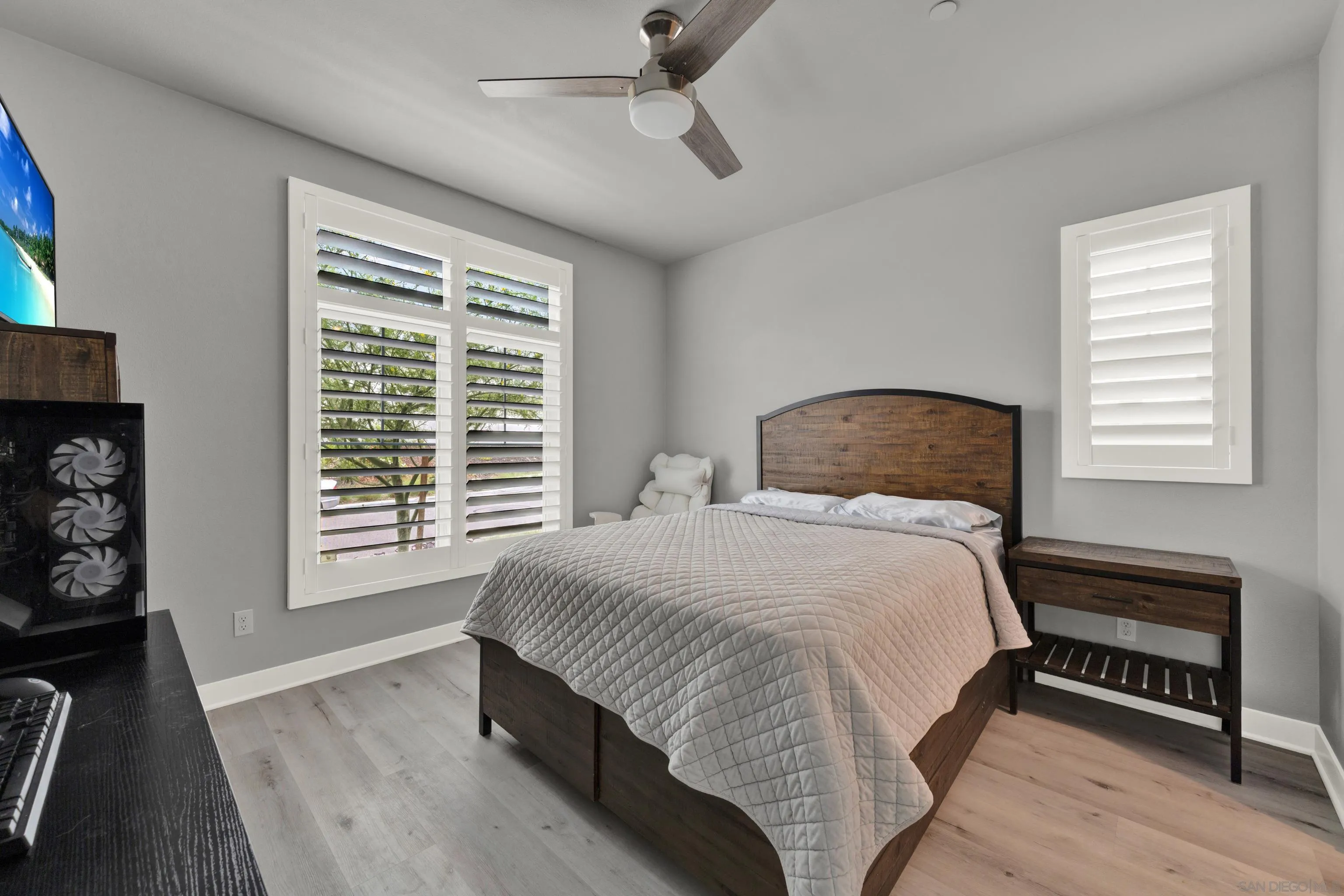 9108 West Bluff Place Santee, CA 92071 - Photo 16 of 72 a bedroom with a bed a dresser and a chandelier