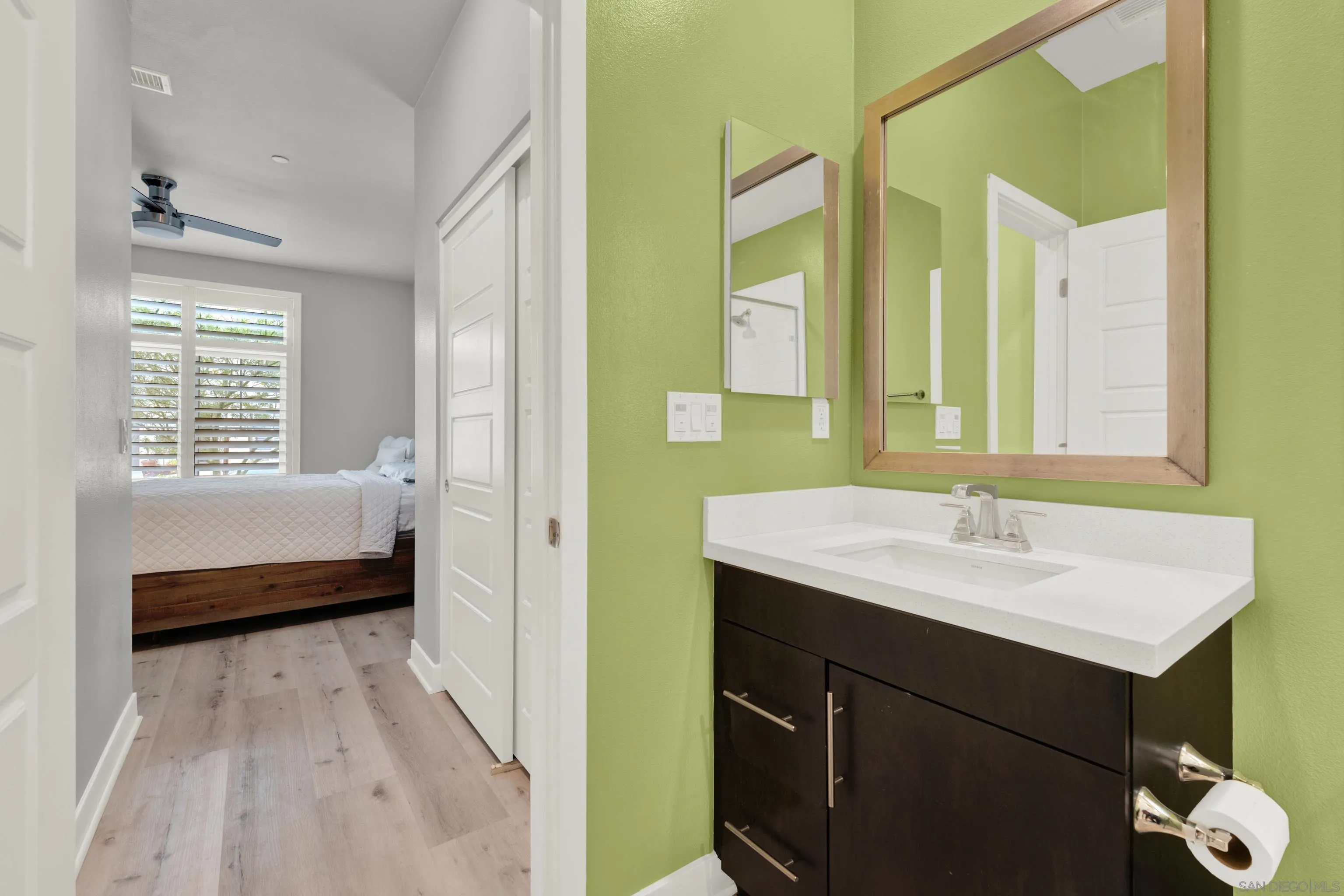 9108 West Bluff Place Santee, CA 92071 - Photo 20 of 72 a en suite bathroom with a sink a mirror and a bathtub