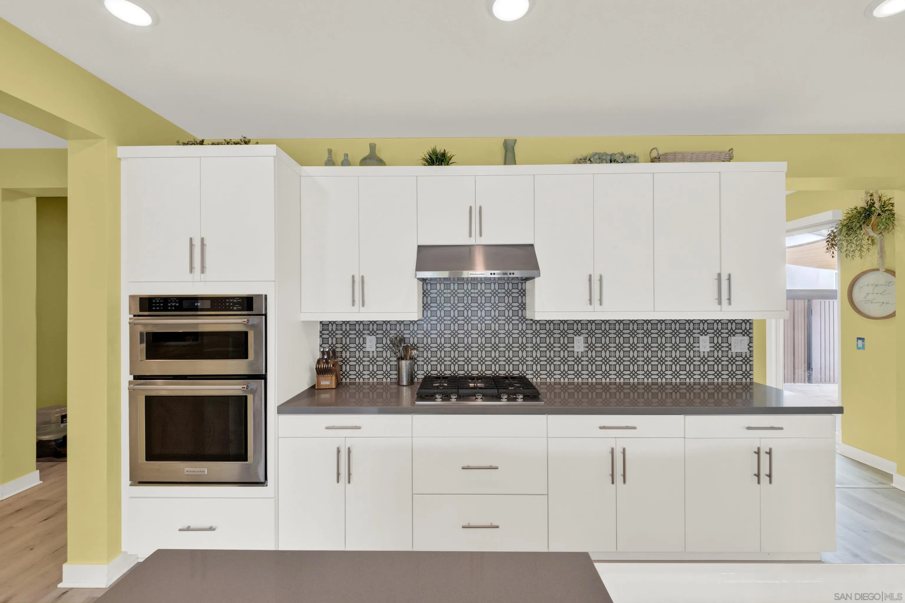 9108 West Bluff Place Santee, CA 92071 - Photo 33 of 72 a kitchen with granite countertop white cabinets and stainless steel appliances