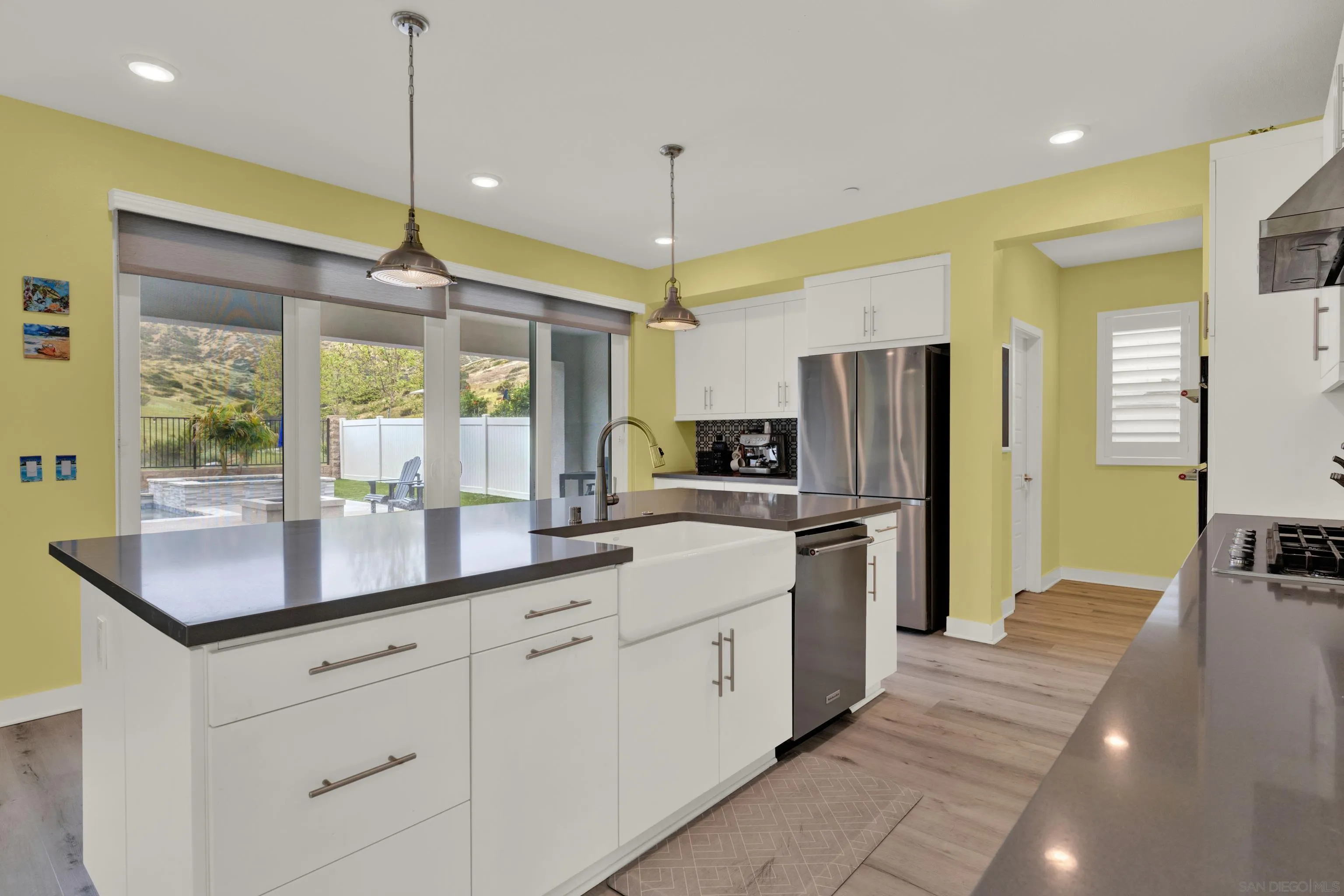 9108 West Bluff Place Santee, CA 92071 - Photo 35 of 72 a kitchen with stainless steel appliances kitchen island granite countertop a sink a stove and a refrigerator