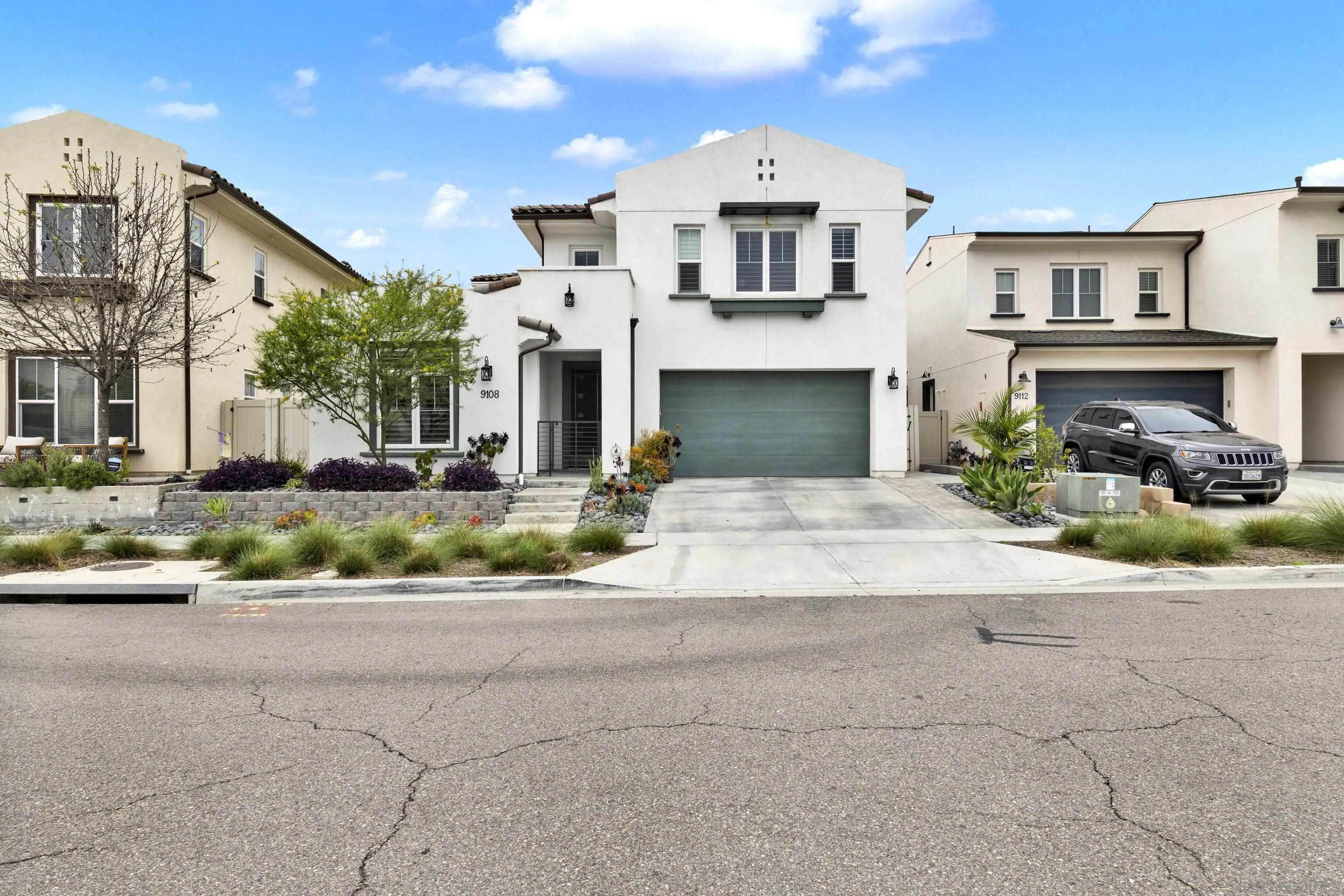 9108 West Bluff Place Santee, CA 92071 - Photo 4 of 72 a front view of a building with garden