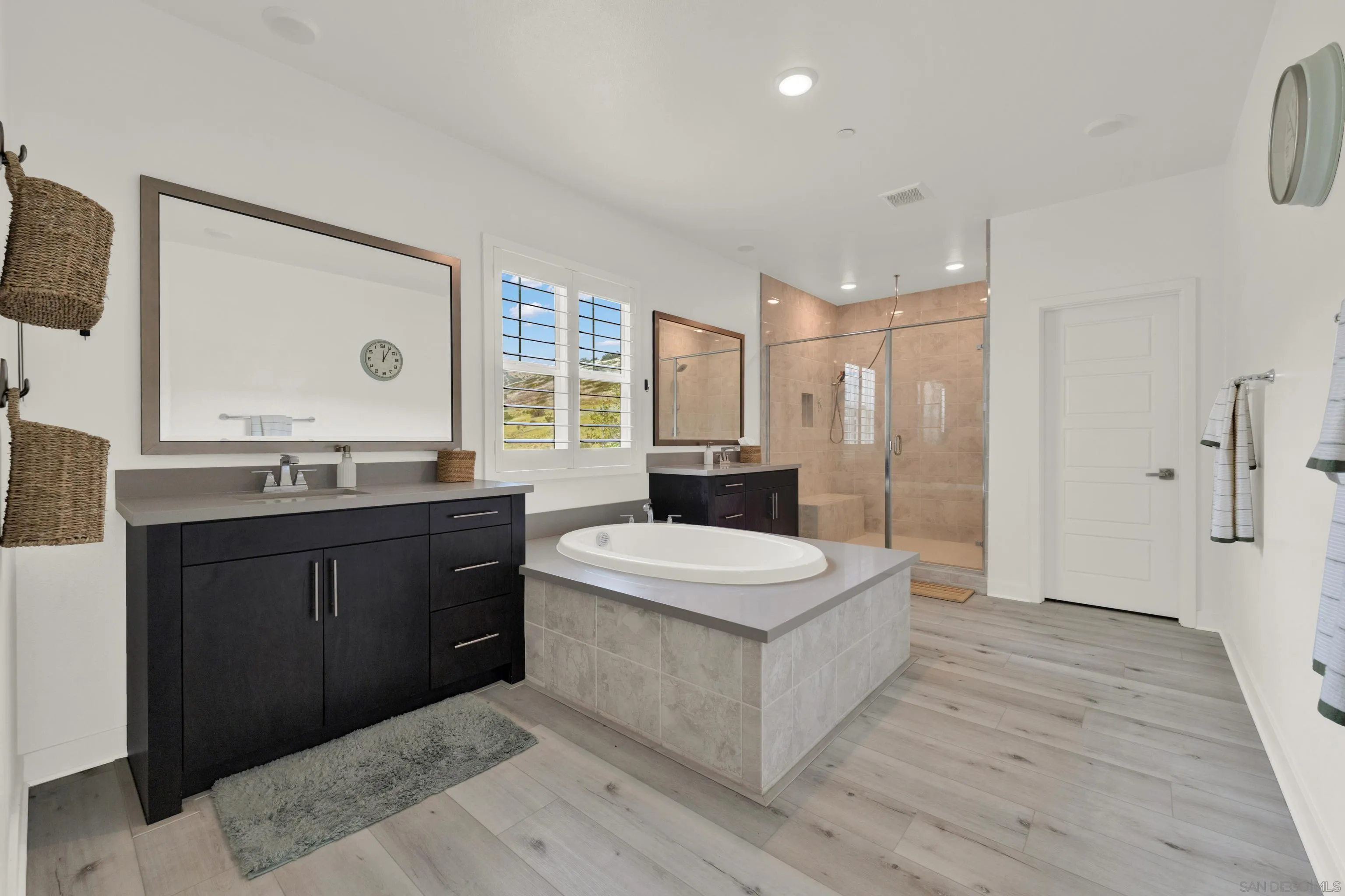 9108 West Bluff Place Santee, CA 92071 - Photo 47 of 72 a spacious bathroom with a bathtub shower sink and mirror