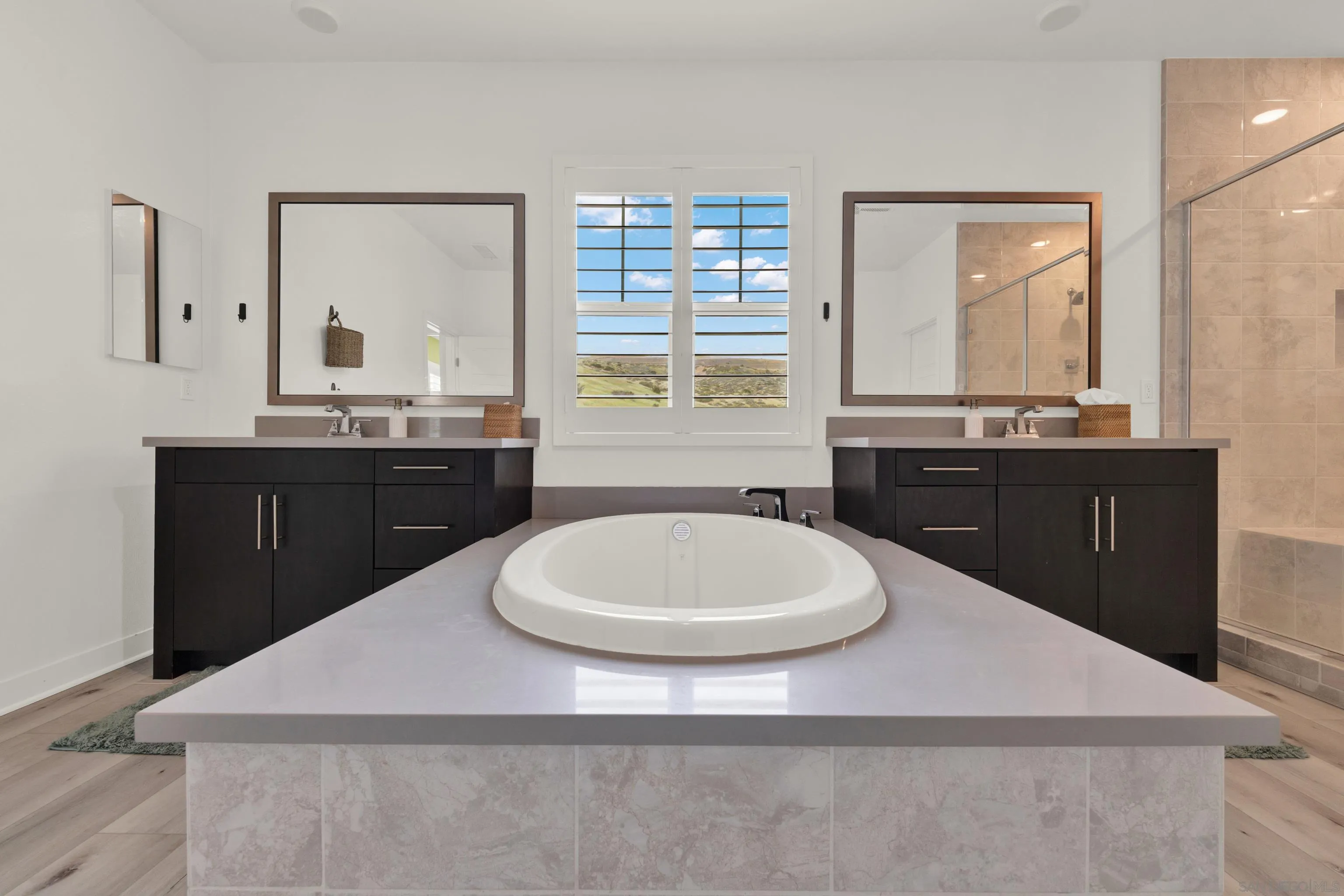 9108 West Bluff Place Santee, CA 92071 - Photo 48 of 72 a bathroom with a sink a mirror and a window