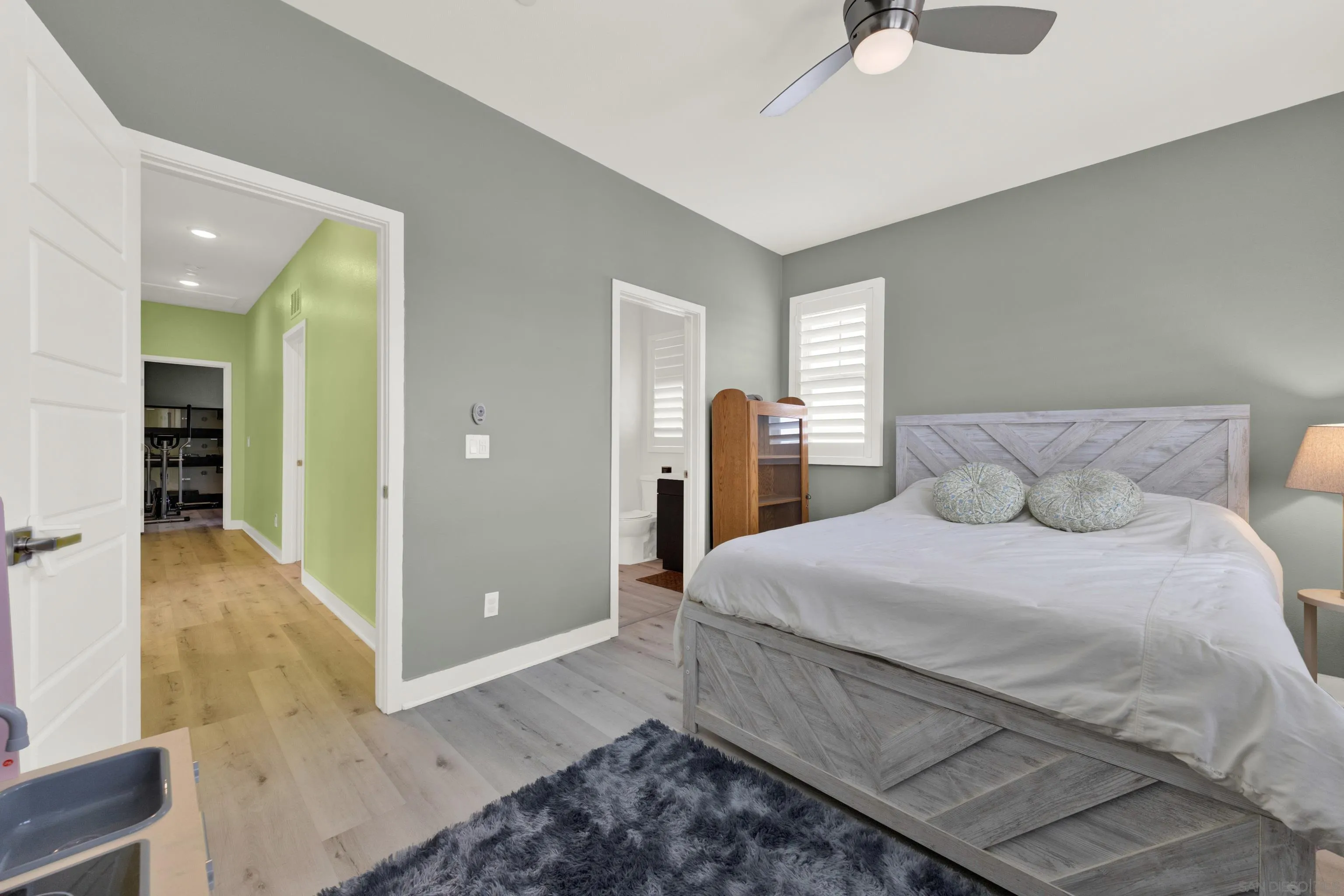 9108 West Bluff Place Santee, CA 92071 - Photo 54 of 72 a spacious bedroom with a bed and a chandelier