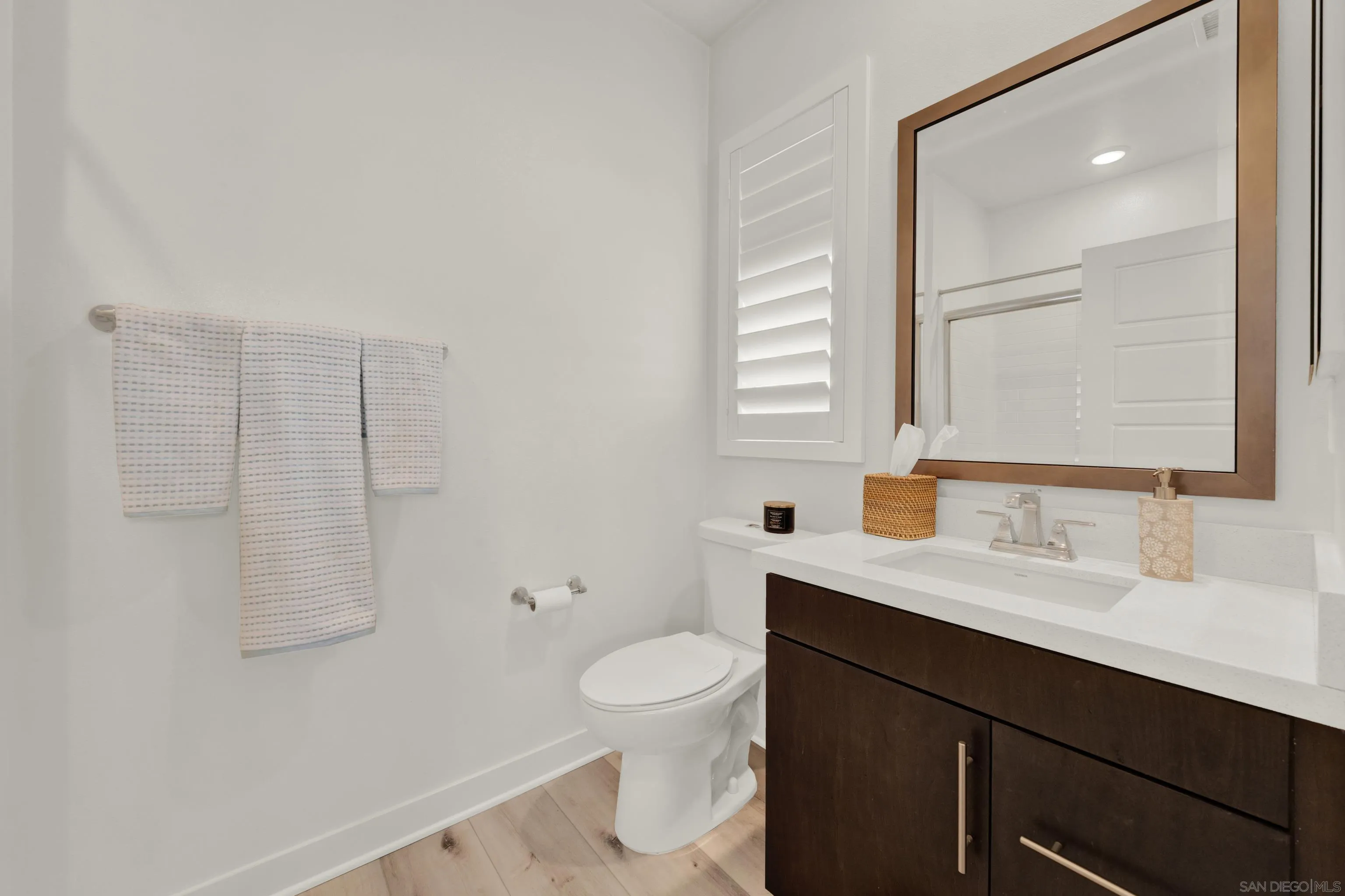 9108 West Bluff Place Santee, CA 92071 - Photo 55 of 72 a bathroom with a sink a toilet and a mirror