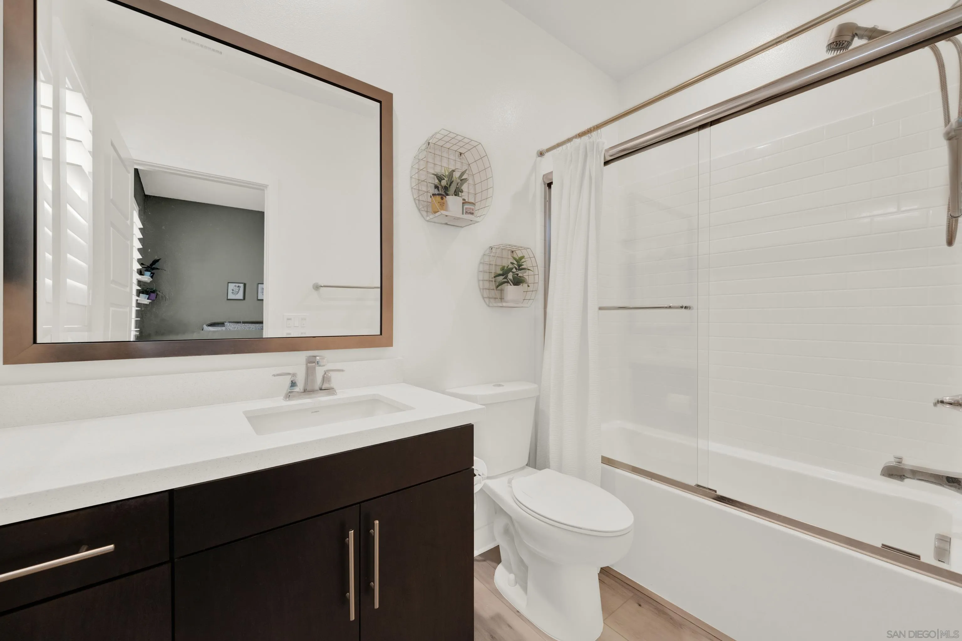 9108 West Bluff Place Santee, CA 92071 - Photo 63 of 72 a bathroom with a sink a toilet a shower and a mirror