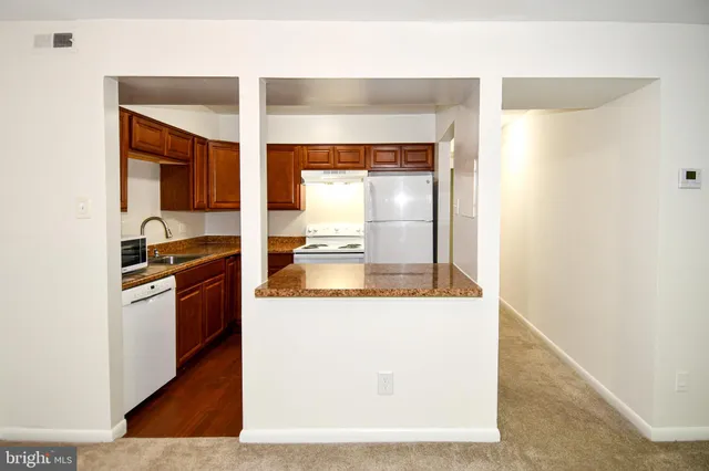 a kitchen with stainless steel appliances granite countertop a stove and a refrigerator