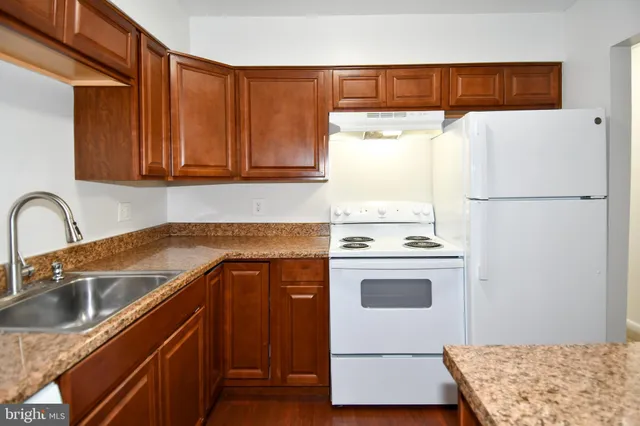 a kitchen with a white cabinets and white appliances