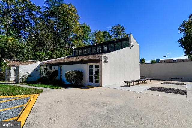 a view of a white house with a yard