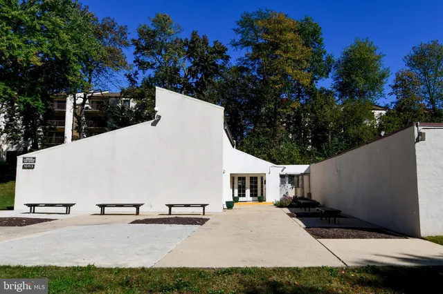 a backyard of a house with lots of green space and fountain