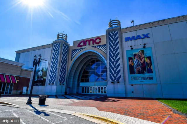 a view of a cars park in front of a building