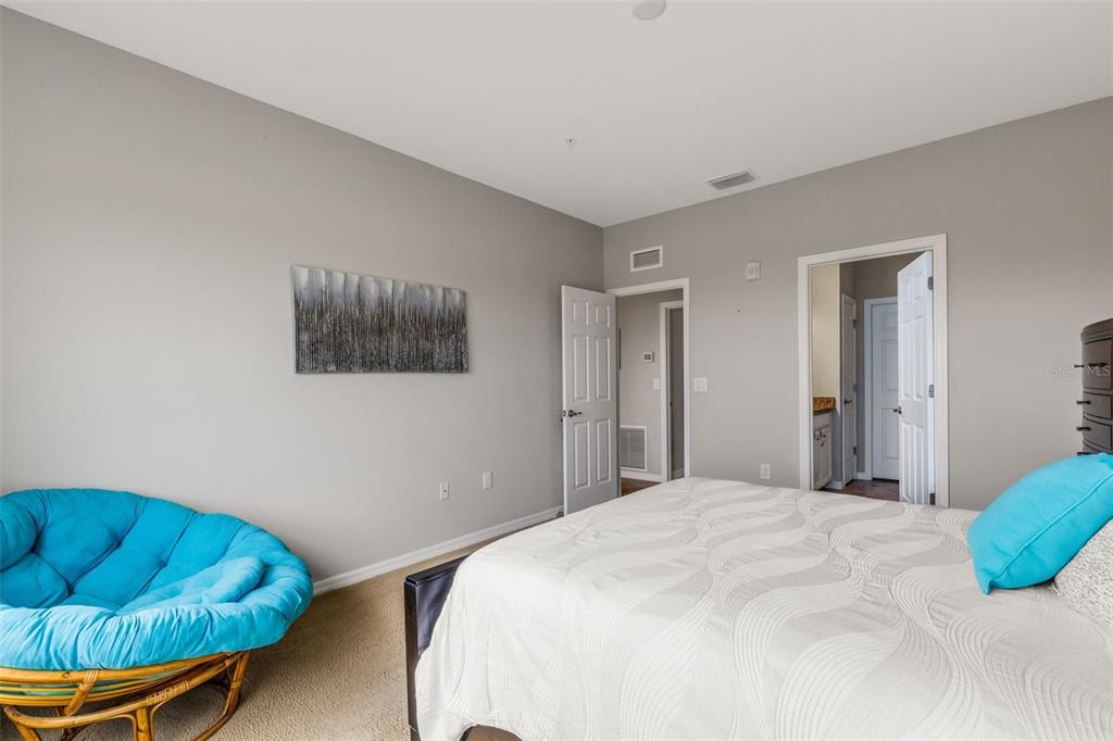 4284 Expedition Way Osprey, FL 34229 - Photo 21 of 40 a bedroom with a bed and a couch