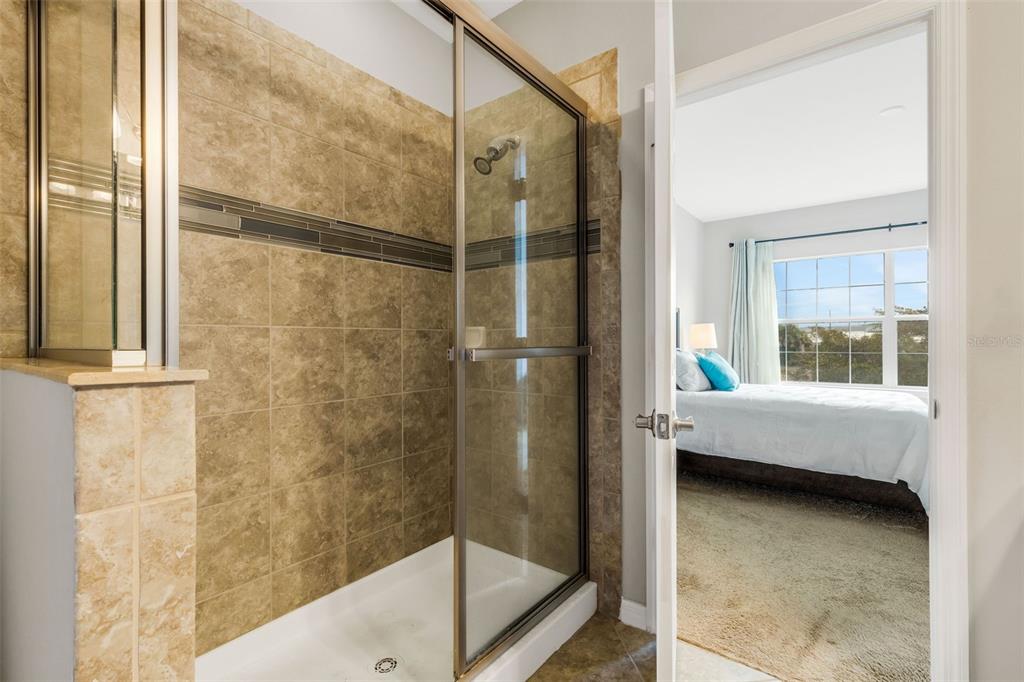 4284 Expedition Way Osprey, FL 34229 - Photo 23 of 40 a bathroom with a tub and shower