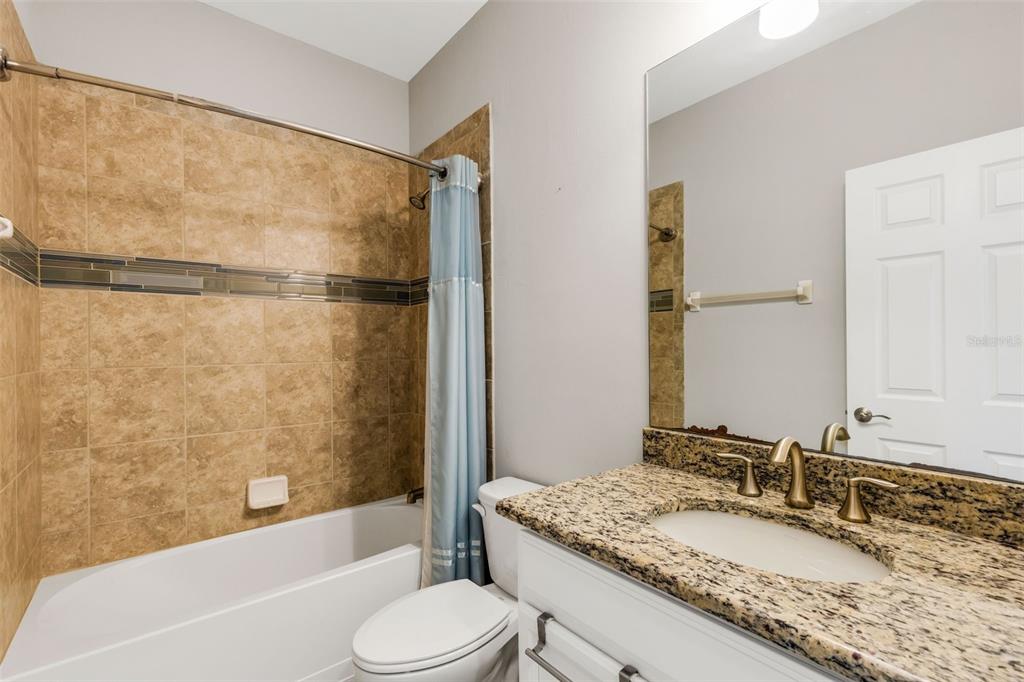 4284 Expedition Way Osprey, FL 34229 - Photo 29 of 40 a bathroom with a granite countertop sink toilet and shower