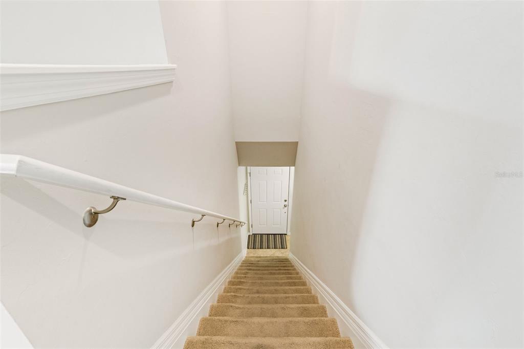 4284 Expedition Way Osprey, FL 34229 - Photo 34 of 40 a view of a hallway with wooden floor and staircase