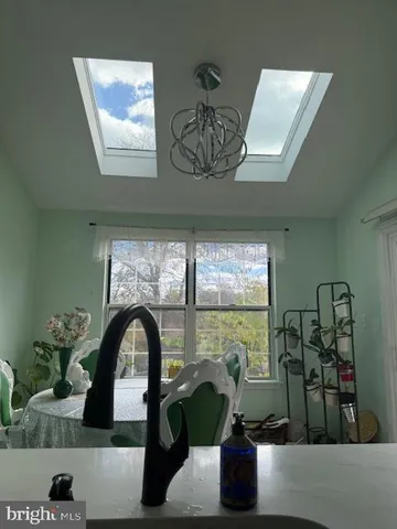 a large kitchen with stainless steel appliances a large counter top a stove a chimney a sink and a refrigerator