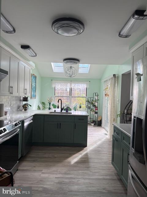 3 Owl Court Marlton, NJ 08053 - Photo 17 of 29 a large kitchen with stainless steel appliances a large counter top a stove a chimney a sink and a refrigerator