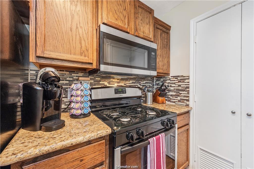 1223 Oney Hervey Drive College Station, TX 77840 - Photo 9 of 22 a kitchen with a stove and a microwave