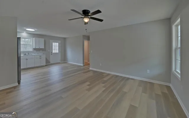 wooden floor in an empty room with a window