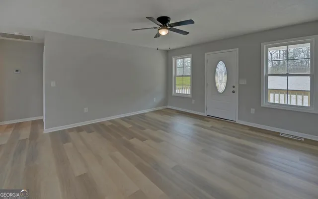wooden floor in an empty room with a window