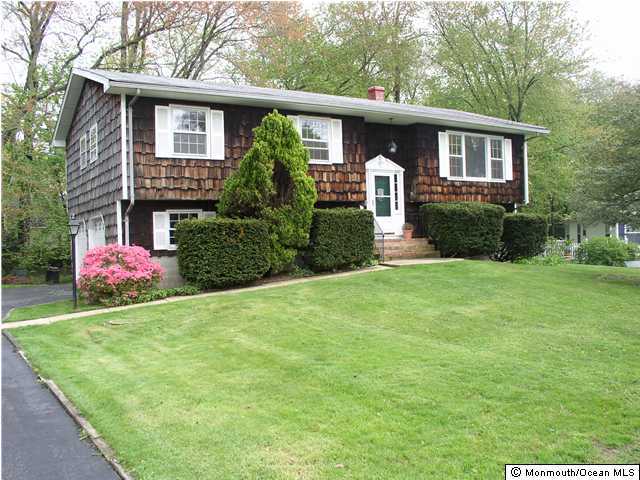 1303 Wedgewood Road Spring Lake, NJ 07762 - Photo 1 of 3 a front view of a house with garden