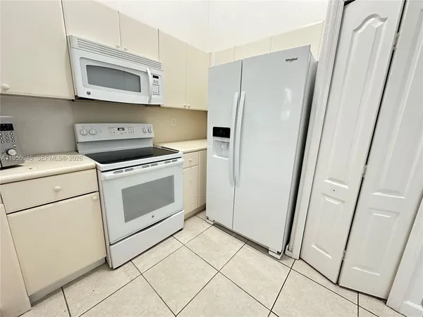 a kitchen with a sink stove and refrigerator