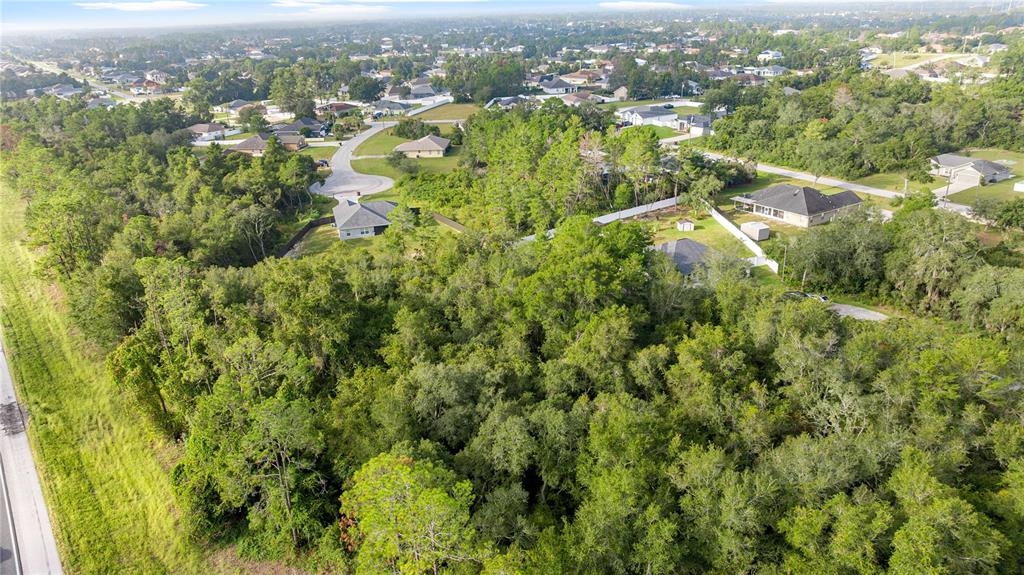 0 Southwest 92nd Lane Ocala, FL 34476 - Photo 4 of 5 an aerial view of residential houses with outdoor space and trees