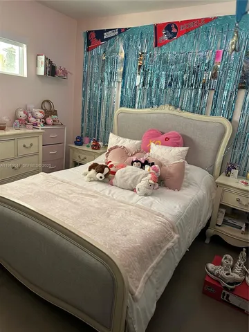 a bed room with a bed and a chair