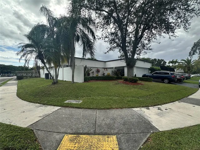 a view of a couches in the patio next to a yard