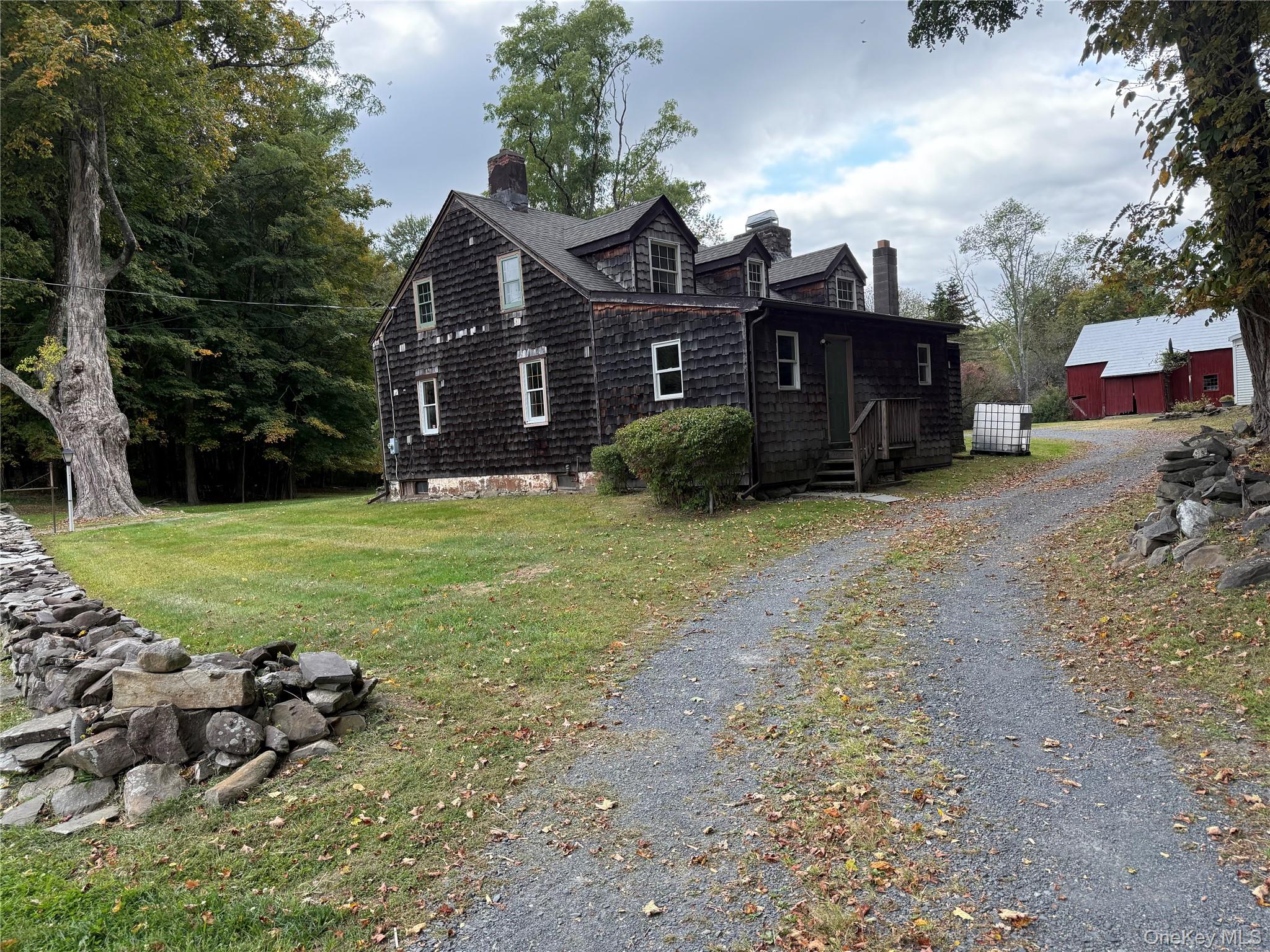241 White Bridge Road Middletown, NY 10940 - Photo 4 of 29 View of side of home with a chimney, driveway, a lawn, and an outdoor structure