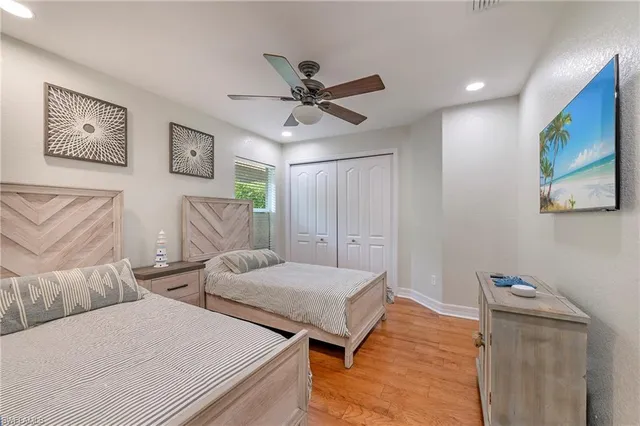 a bedroom with two beds and painting on the wall