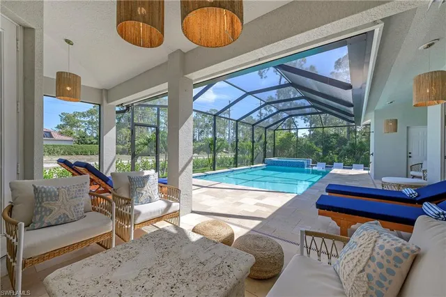 a living room with furniture and a floor to ceiling window