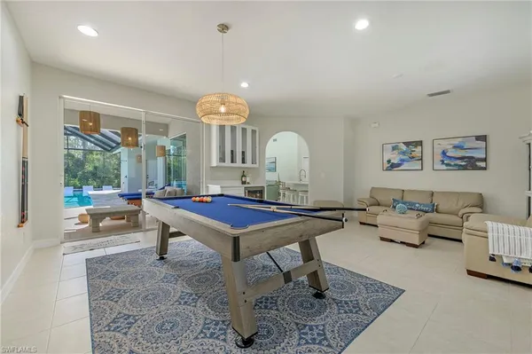 a living room with furniture a rug and a large window