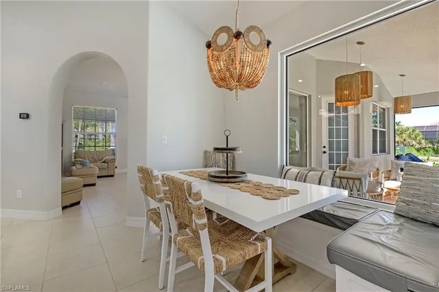 a view of a dining room with furniture and a chandelier