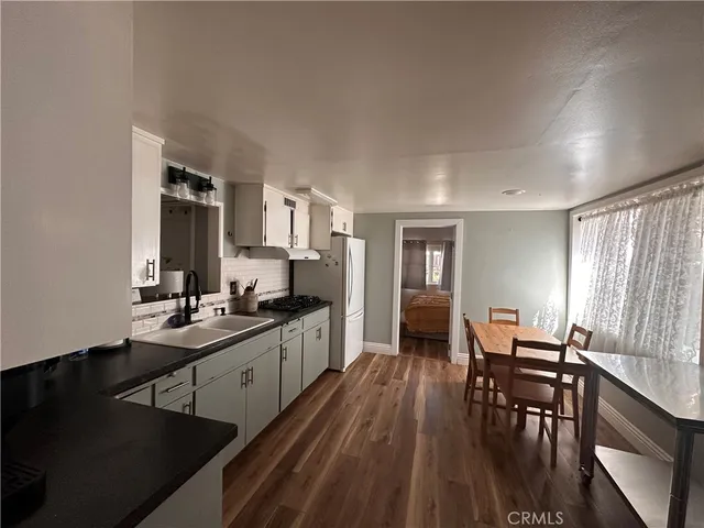 a kitchen with sink stove and dining table