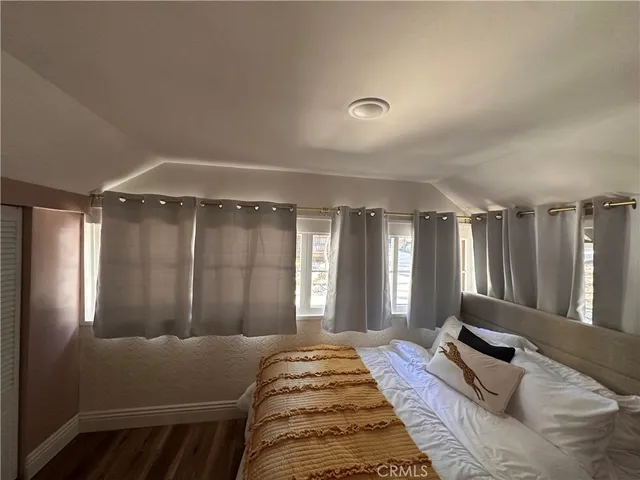 a bedroom with a large bed and a large window