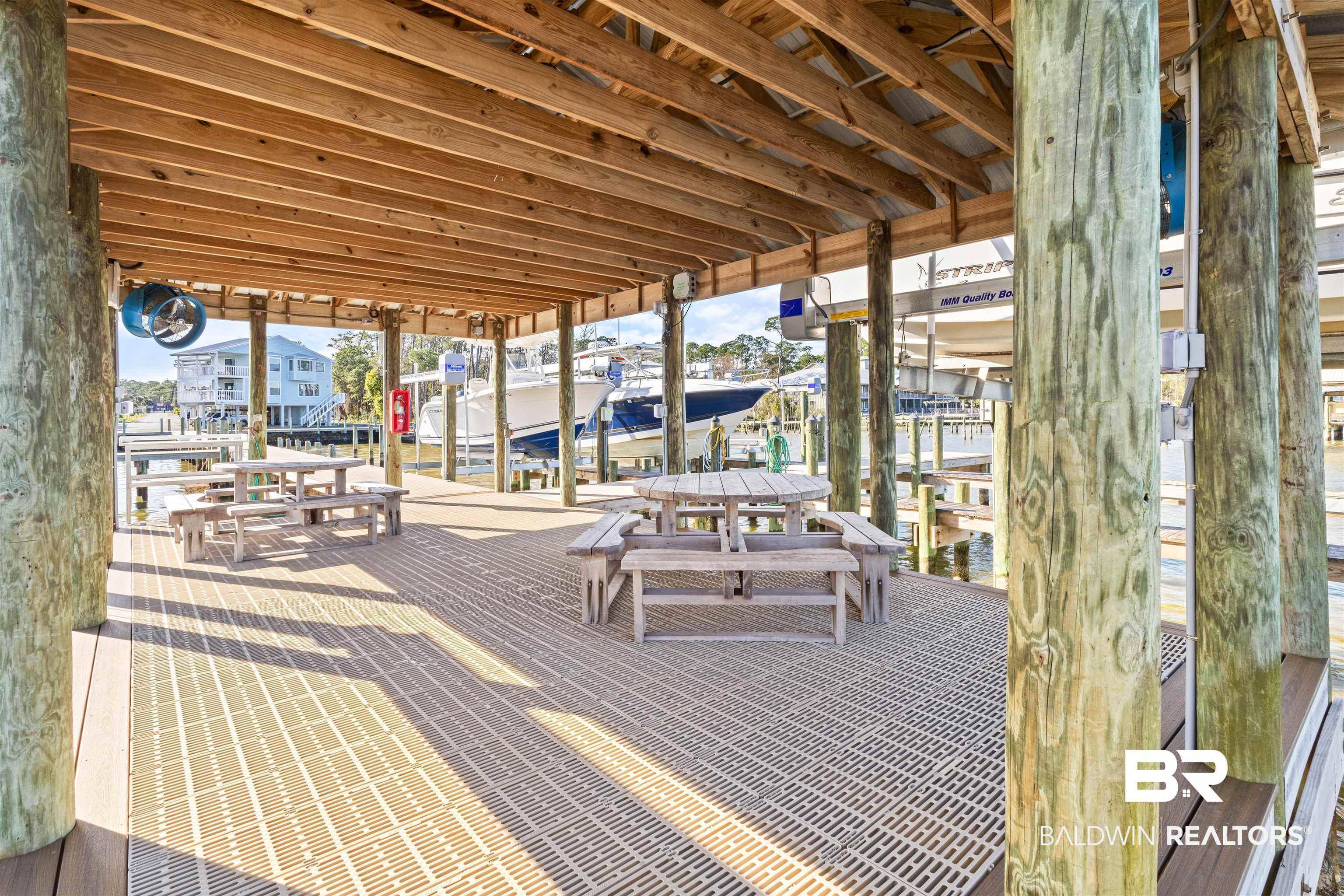 25861 Canal Road, Unit 3 Orange Beach, AL 36561 - Photo 30 of 40 Deck featuring a water view, boat lift, and a boat dock