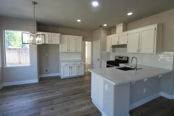 a kitchen with kitchen island a sink stainless steel appliances and window