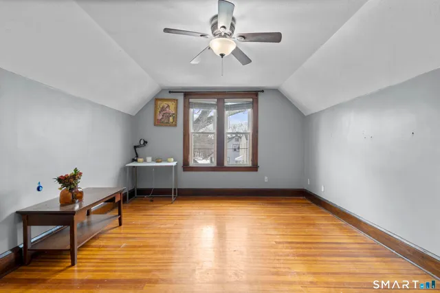 a bedroom with furniture and wooden floor