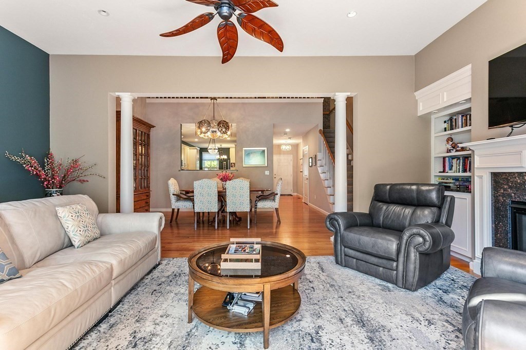 36 Owen Road, Unit 36 Norton, MA 02766 - Photo 14 of 40 a living room with furniture a flat screen tv and a chandelier