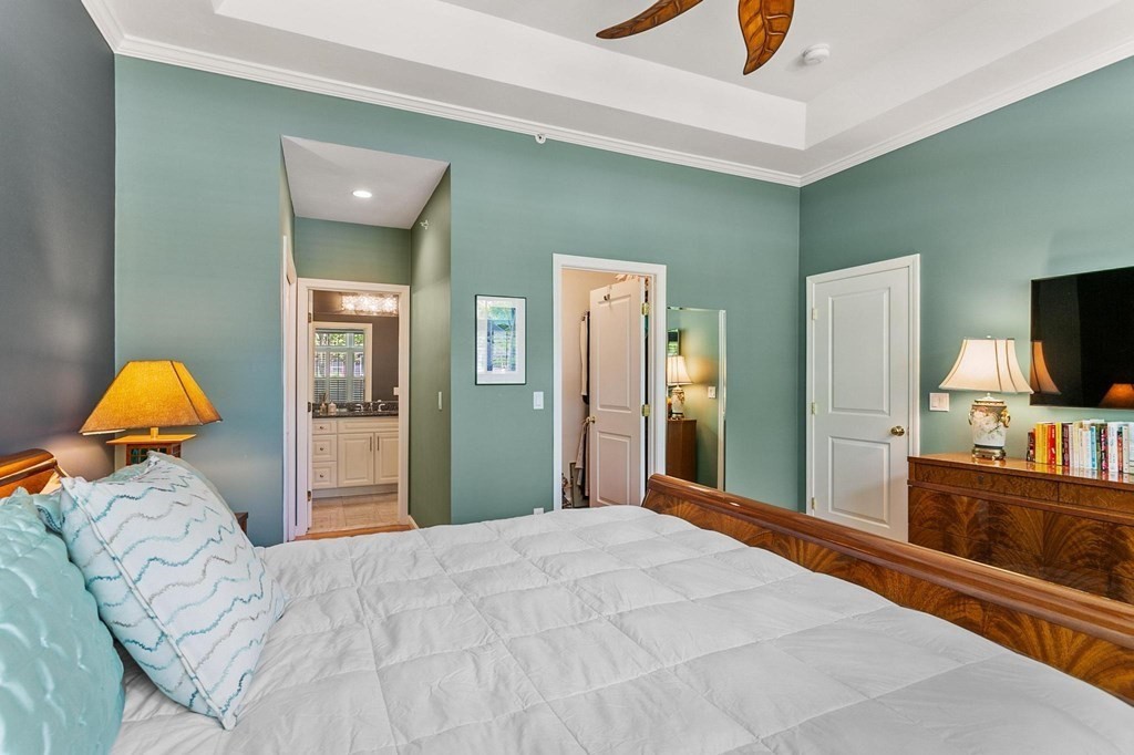 36 Owen Road, Unit 36 Norton, MA 02766 - Photo 18 of 40 a bedroom with a bed and a flat screen tv