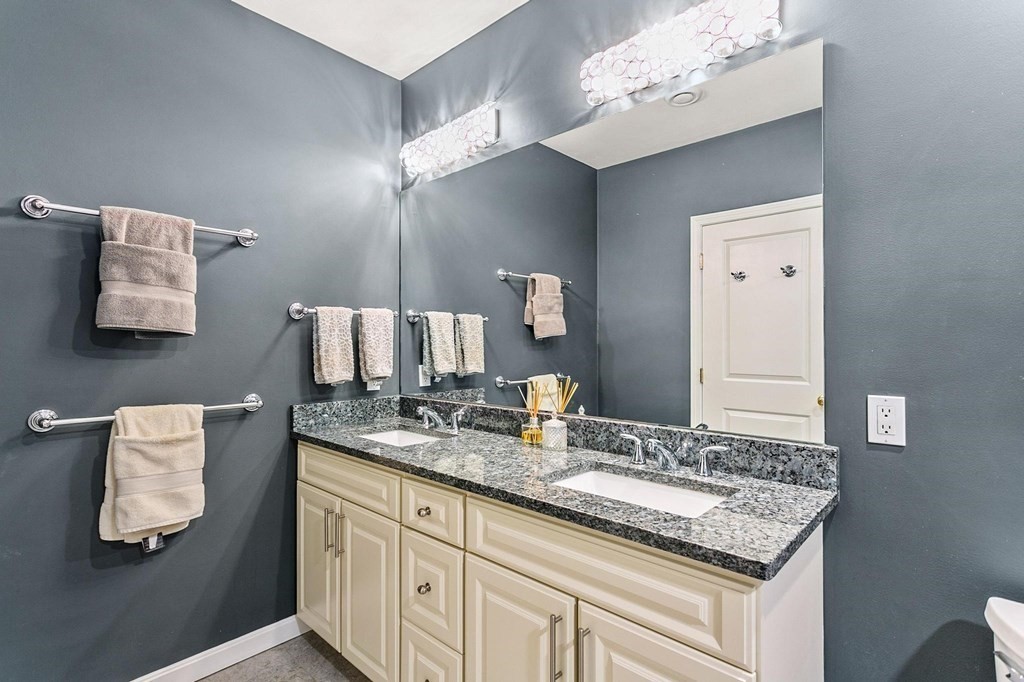 36 Owen Road, Unit 36 Norton, MA 02766 - Photo 20 of 40 a bathroom with a granite countertop sink and a mirror