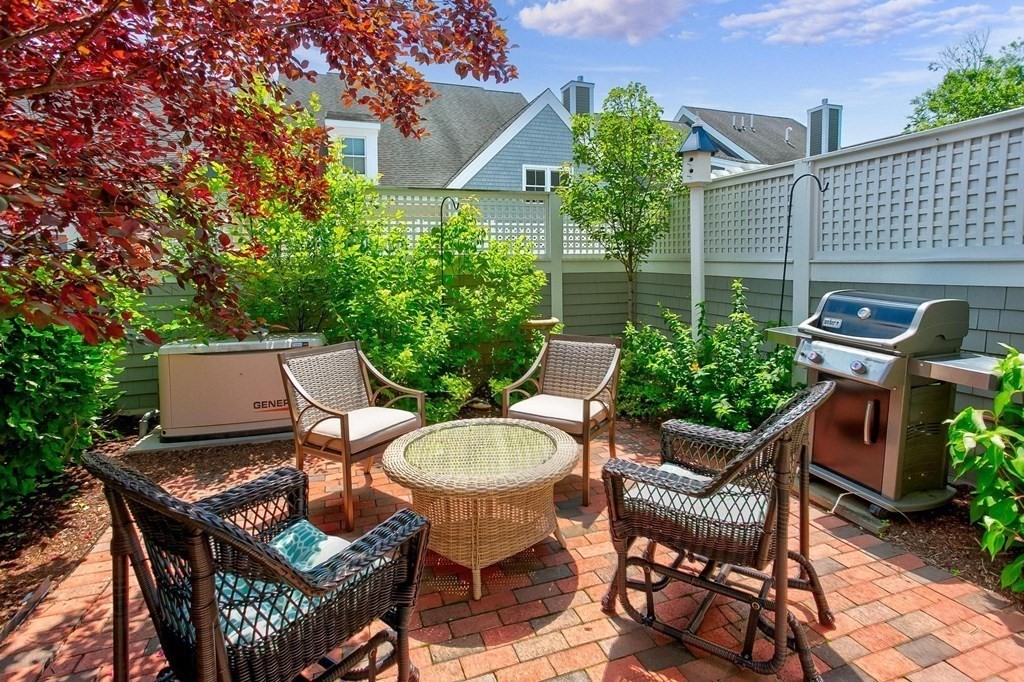 36 Owen Road, Unit 36 Norton, MA 02766 - Photo 27 of 40 a backyard of a house with table and chairs