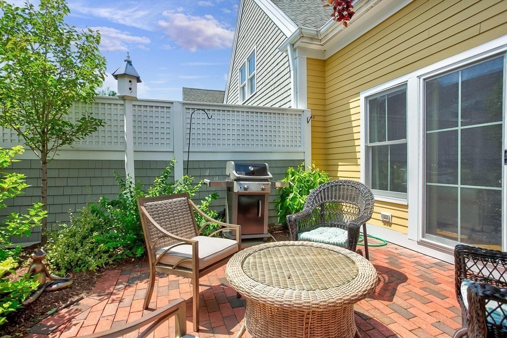 36 Owen Road, Unit 36 Norton, MA 02766 - Photo 29 of 40 a view of a patio with table and chairs and potted plants