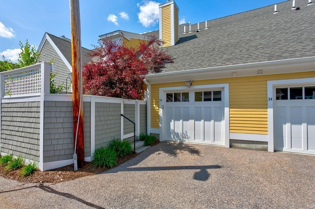 36 Owen Road, Unit 36 Norton, MA 02766 - Photo 30 of 40 a front view of a house with a yard and garage