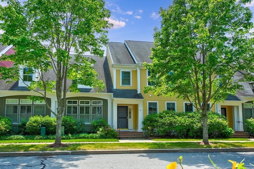 36 Owen Road, Unit 36 Norton, MA 02766 - Photo 34 of 40 a front view of a house with a yard and large trees