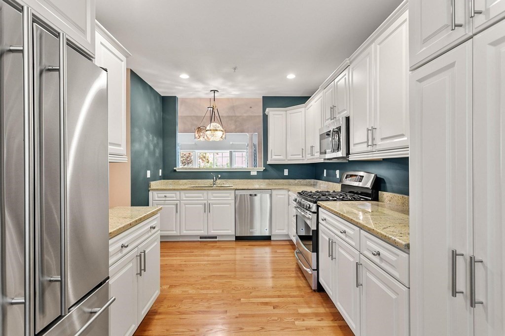 36 Owen Road, Unit 36 Norton, MA 02766 - Photo 6 of 40 a kitchen with white cabinets and white appliances