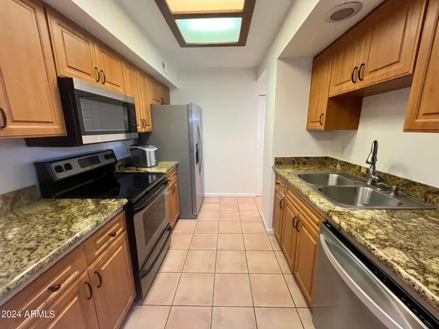 a kitchen with a sink and a stove top oven